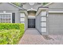 Home exterior featuring a double door, landscaped front yard and architectural details at 131 Calabria Springs Cv, Sanford, FL 32771