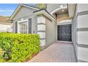 Home exterior featuring a double door, landscaped front yard and architectural details at 131 Calabria Springs Cv, Sanford, FL 32771