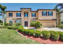Inviting two-story home with a manicured lawn, mature landscaping, and a welcoming entrance at 17117 Cypress Preserve Pkwy, Orlando, FL 32820