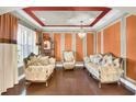 Elegant living room with ornate furniture, recessed lighting, and custom wall paneling at 17117 Cypress Preserve Pkwy, Orlando, FL 32820