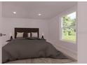 Cozy bedroom with a comfortable bed and a large window view at 17445 Sw 25Th Ct, Ocala, FL 34473
