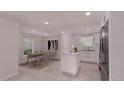 Modern kitchen features an island, stainless steel appliances, and a bright dining area at 17445 Sw 25Th Ct, Ocala, FL 34473