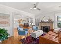 Open-concept living room featuring hardwood floors, fireplace, and comfortable seating at 210 E Kaley St, Orlando, FL 32806