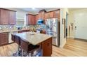 Open kitchen featuring a large island, granite countertops, and stainless steel appliances at 2331 Kennington Cv, Deland, FL 32724