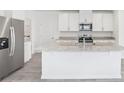 Modern kitchen with granite countertops, stainless steel appliances, large island, and tile flooring at 2774 Virginia Pine Dr, Bartow, FL 33830