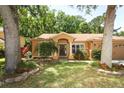 Charming single-story home featuring a landscaped yard and inviting front porch at 304 Little Springs Ln, Longwood, FL 32750