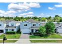 Aerial view of a charming two-story home with a well-manicured lawn and inviting front entrance at 3259 Buoy Cir, Winter Garden, FL 34787