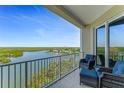 Relax on the private balcony with comfortable seating, enjoying the scenic waterfront and mangrove views at 5 Riverwalk Dr # 604, New Smyrna Beach, FL 32169