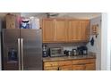 Bright kitchen featuring stainless steel appliances, granite countertops and a light wood cabinets at 614 Gaul Way, Kissimmee, FL 34759