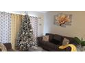 Cozy living room with modern decor, neutral walls and a comfortable gray sofa at 614 Gaul Way, Kissimmee, FL 34759