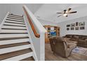 Inviting living room featuring hardwood floors, ceiling fan, and a staircase leading to the upper level at 6218 Forsythe Loop, Sanford, FL 32771