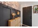 Stylish entryway features a brick accent wall, coat rack, and shoe storage at 731 Rosemere Cir, Orlando, FL 32835