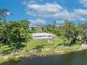 Back of home view featuring spacious lot with lake view at 7420 Lake Willis Dr, Orlando, FL 32821