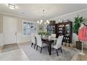 Elegant dining room with a chandelier, wainscoting, and ample natural light at 11725 Verrazano Dr, Orlando, FL 32836
