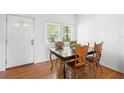 Cozy dining room with hardwood floors, a large window, and a table with four chairs at 1207 Cole Rd, Orlando, FL 32803