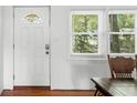Bright entryway featuring a decorative glass front door, natural light from the window, and hardwood floors at 1207 Cole Rd, Orlando, FL 32803