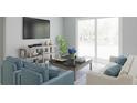 Bright living room with large window, neutral walls, modern furnishings, and stylish decor at 13232 Pergola Ave, Orlando, FL 32832