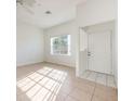 Bright living room with neutral tile flooring, ceiling fan, and natural light at 133 Reserve Cir # 109, Oviedo, FL 32765