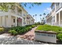 Picturesque Twin Oaks Mews community entrance with lush landscaping and charming homes at 1516 Resolute St, Celebration, FL 34747