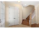 Entryway with wood stairs, tile floors, and closet at 1516 Resolute St, Celebration, FL 34747