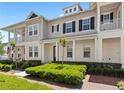 Charming townhome featuring a covered porch, neat landscaping, and a welcoming facade at 1516 Resolute St, Celebration, FL 34747
