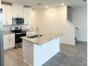 Bright kitchen with white cabinets, stainless appliances, and a large center island at 16284 Hamlin View St, Winter Garden, FL 34787
