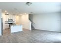 Open-concept living space with tile flooring and ample natural light, flowing into the kitchen at 16284 Hamlin View St, Winter Garden, FL 34787