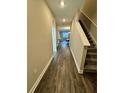 Inviting foyer featuring sleek wood-look flooring leading to stairs and adjacent living spaces at 16290 Hamlin View St, Winter Garden, FL 34787