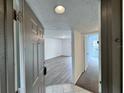 View of condo entrance with tile flooring and entry to living space with laminate flooring at 1908 Lake Atriums Cir # 20, Orlando, FL 32839