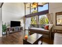 Cozy living room featuring hardwood floors, large windows, television, and comfortable seating at 200 Maitland Ave # 28, Altamonte Springs, FL 32701