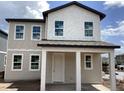 New two story home with covered porch and large windows offering natural light and modern design, new construction at 2389 Zuni Road, St Cloud, FL 34771