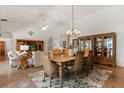 Elegant dining room with a large table, chandelier, and a china cabinet for displaying fine tableware at 24104 Peekskill St, Leesburg, FL 34748