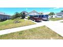 Inviting two-story home with lush landscaping and a spacious driveway at 2426 Hybrid Dr, Kissimmee, FL 34758