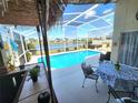 Relaxing screened-in pool area with lake view and ample seating at 2426 Hybrid Dr, Kissimmee, FL 34758