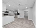 Bright kitchen area with stainless steel appliances, gray wood flooring, and an open floorplan at 2614 Rio Ln, Orlando, FL 32805