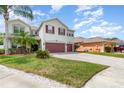 Charming two-story home featuring a two-car garage, landscaped yard, and a welcoming facade at 289 Magnolia Park Trl, Sanford, FL 32773