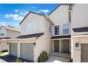 Charming exterior featuring an attached garage, tidy landscaping, and a well-maintained facade with neutral color scheme at 3004 Cottage Grove Ct # 1805, Orlando, FL 32822