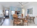 Cozy dining area with a table, stylish chairs, ceiling fan, and adjacent kitchen at 3221 Westridge Blvd # 103, Orlando, FL 32822