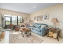 Bright living room featuring a comfortable sofa, accent furniture, and a sliding door to the patio at 3221 Westridge Blvd # 103, Orlando, FL 32822