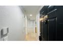 Clean hallway with light grey walls and tile floors leading to an open floor plan at 3702 Palm Desert Ln # 5435, Orlando, FL 32839