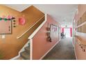 Inviting hallway leads to carpeted stairs and a dining area, creating a warm and welcoming atmosphere at 3759 Collingwood Ln, Oviedo, FL 32765