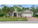 Charming single-Gathering home boasting a well-kept lawn, decorative shutters, and a convenient two-car garage at 3824 Gulf Shore Cir, Kissimmee, FL 34746