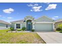 Attractive single-story home with an attached two-car garage, neat landscaping, and a freshly cut lawn at 4153 Cortland Dr, Davenport, FL 33837