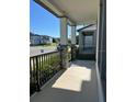 View of the cozy front porch showing decorative columns and black metal railing at 4716 Homestead Trl, St Cloud, FL 34772