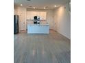 Modern kitchen with white cabinetry, stainless steel appliances, and light tile flooring at 4720 Homestead Trl, St Cloud, FL 34772