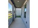 A cozy, grey-toned front porch with modern railings and a peaceful outdoor space at 4720 Homestead Trl, St Cloud, FL 34772