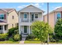 Charming two-story home with a covered porch and manicured landscaping at 5711 Hamlin Groves Trl, Winter Garden, FL 34787