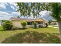 A charming single-story home with a well-manicured lawn, mature trees, and a welcoming facade at 6366 Sw 115Th Street Rd, Ocala, FL 34476
