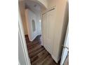 Hallway with laminate flooring leading to bedroom, closet with double doors at 7314 Seena Ct, Orlando, FL 32835