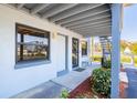 Comfortable condo with a white entrance door, bench, and a staircase at 865 Ladyfish Ave # C104, New Smyrna Beach, FL 32169